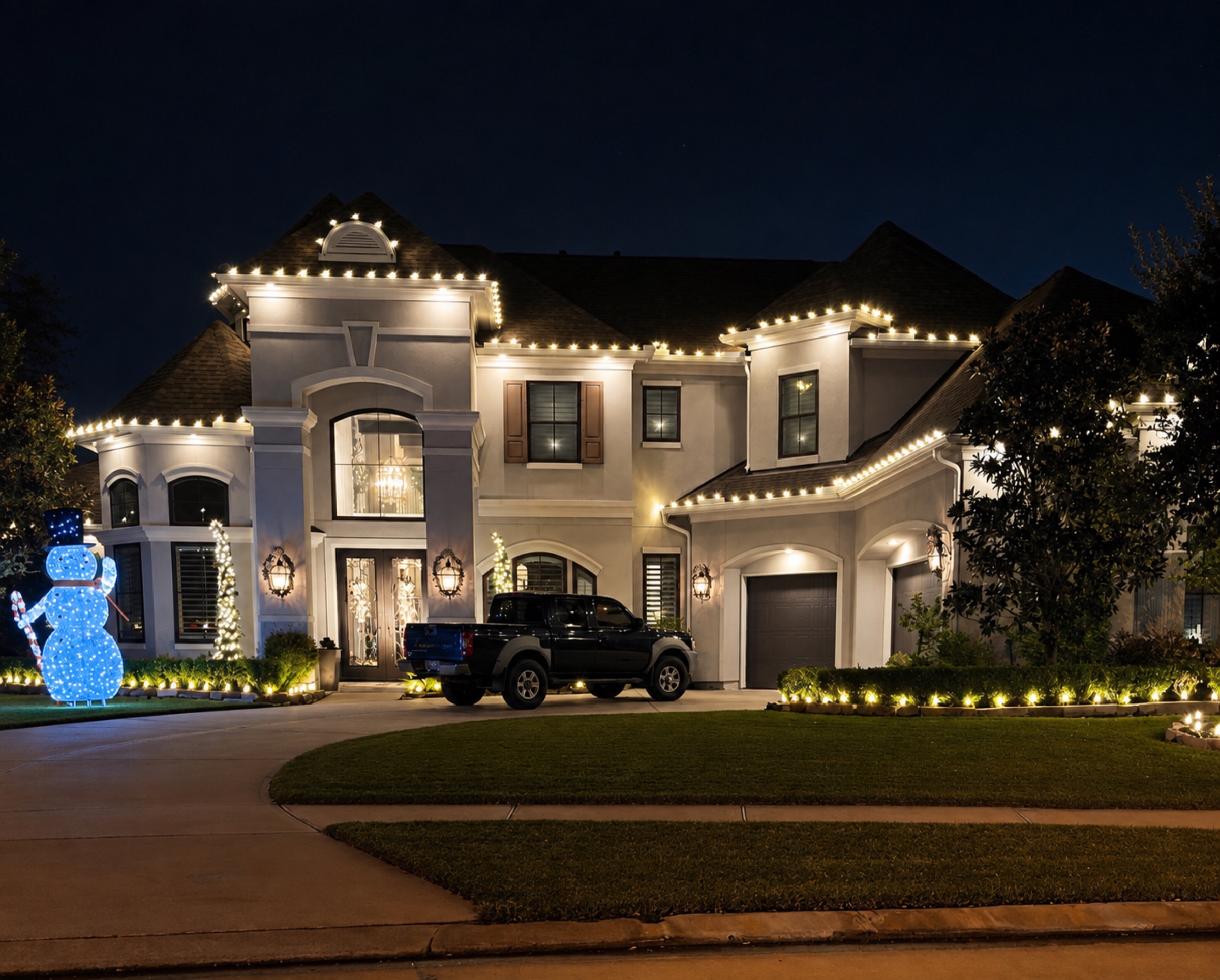 Luxury Houston-area home professionally decorated with warm white Christmas lights.